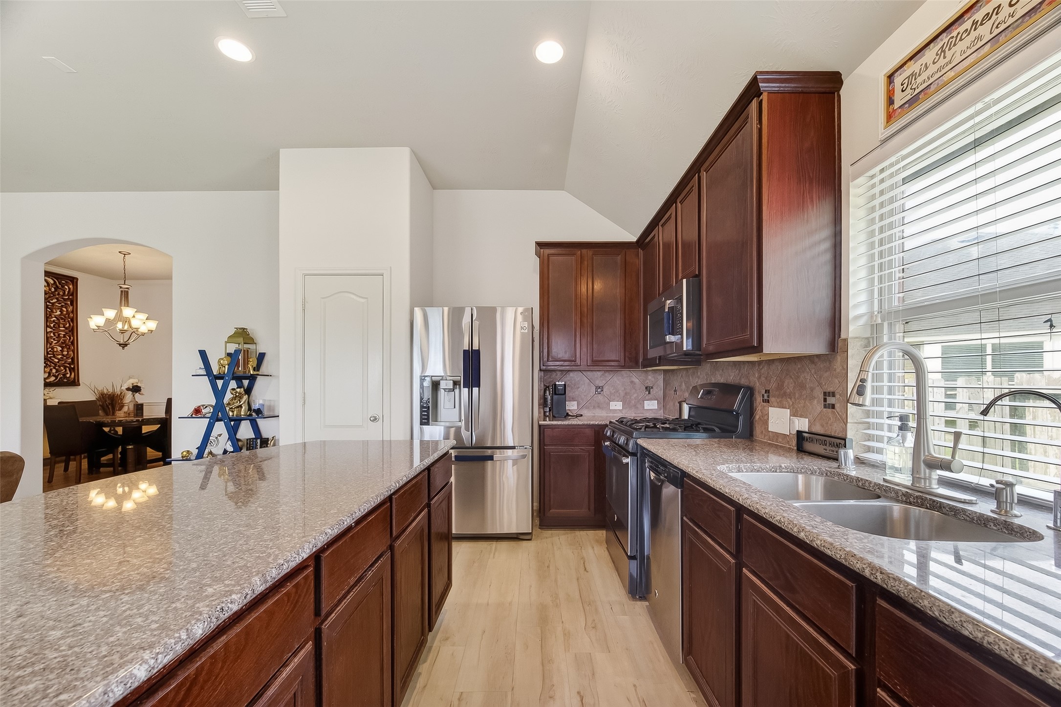 13415 Star Creek Lane Rosharon, TX 77583 - Photo 18 of 46 a kitchen with stainless steel appliances granite countertop sink stove refrigerator and cabinets