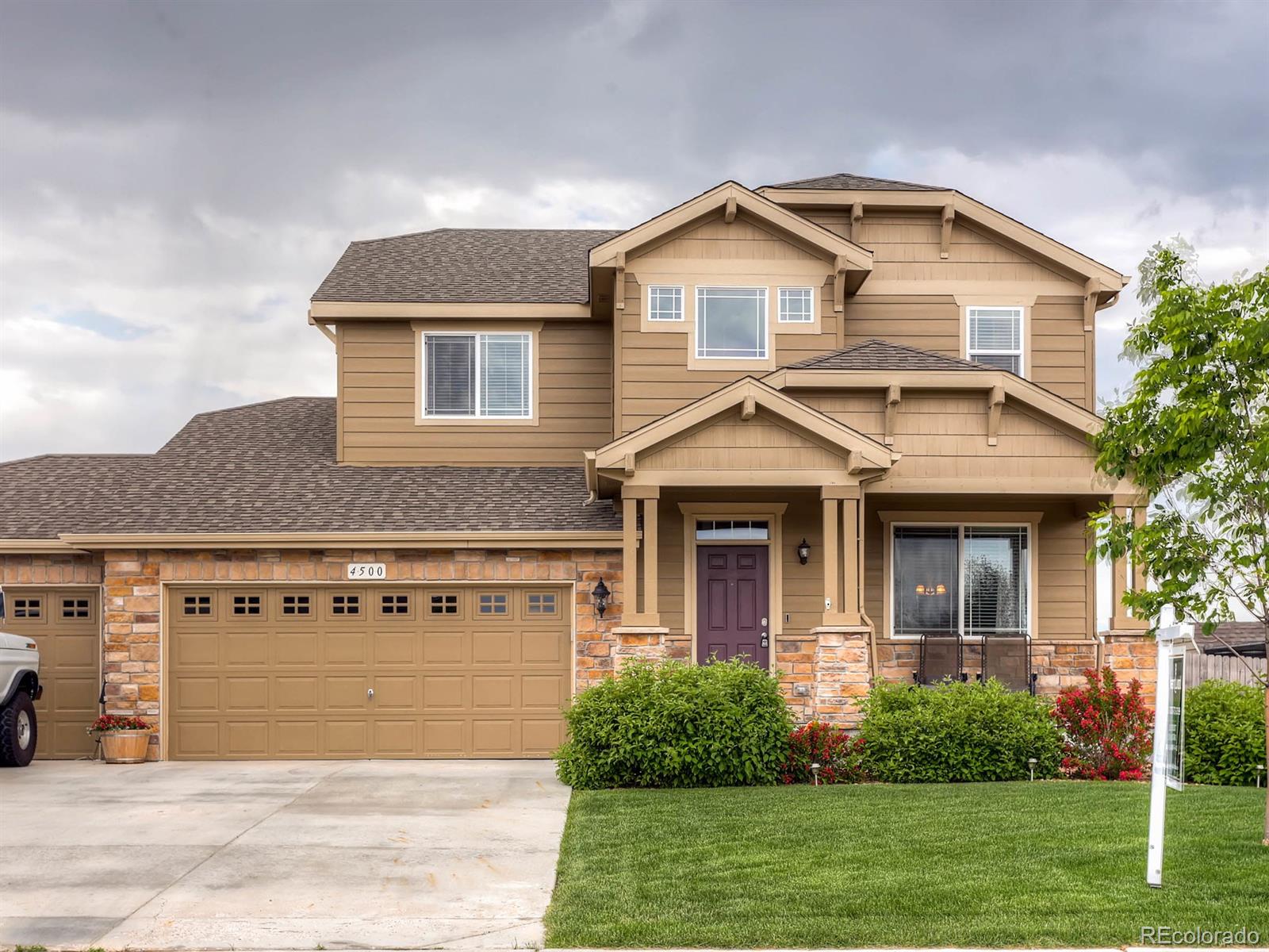 4500 Bramble Road Frederick, CO 80504 - Photo 1 of 25 a front view of a house with a yard and garage