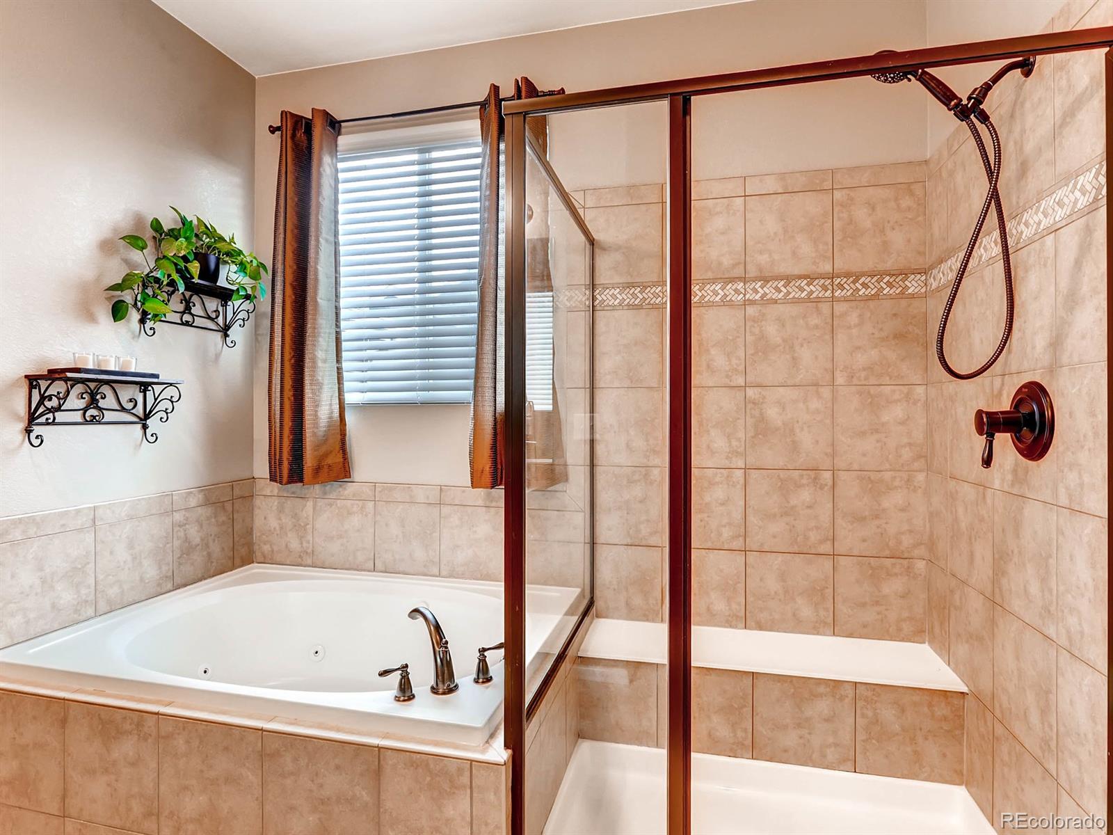 4500 Bramble Road Frederick, CO 80504 - Photo 13 of 25 a bathroom with a bathtub and a shower