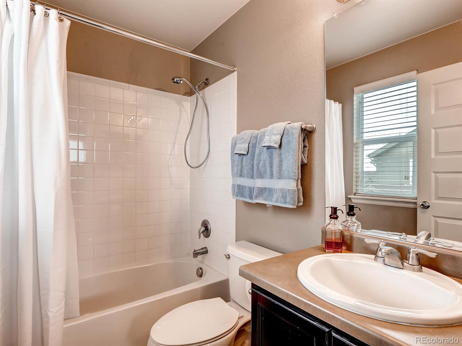 4500 Bramble Road Frederick, CO 80504 - Photo 17 of 25 a bathroom with a sink toilet and shower