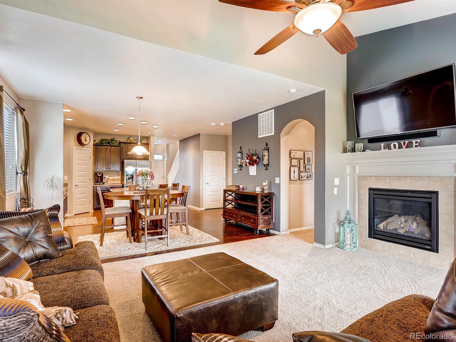 4500 Bramble Road Frederick, CO 80504 - Photo 4 of 25 a living room with furniture fireplace and flat screen tv