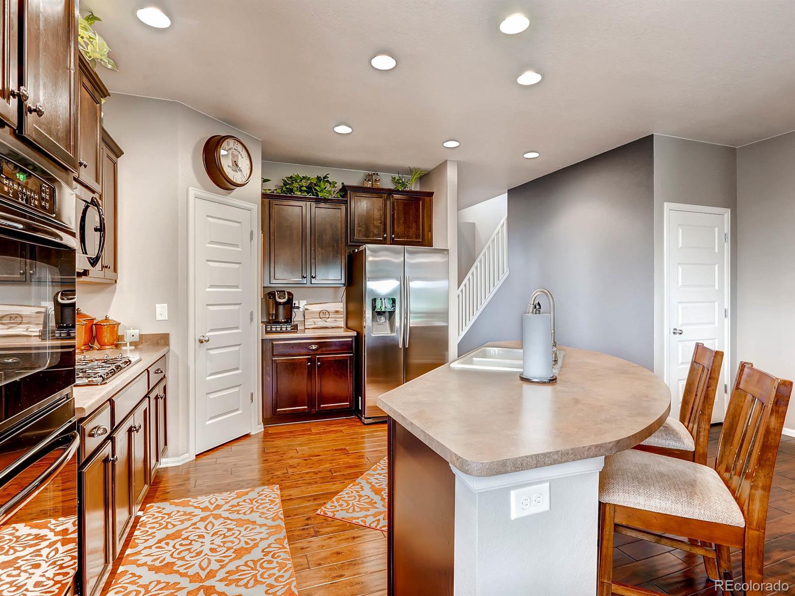 4500 Bramble Road Frederick, CO 80504 - Photo 6 of 25 a kitchen with stainless steel appliances granite countertop a sink and a refrigerator