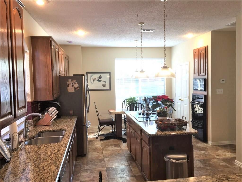 4309 Mead Drive Plano, TX 75024 - Photo 15 of 25 a kitchen with stainless steel appliances kitchen island granite countertop a refrigerator a sink and a stove