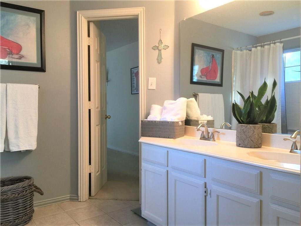 4309 Mead Drive Plano, TX 75024 - Photo 19 of 25 a bathroom with a granite countertop sink a mirror and a shower