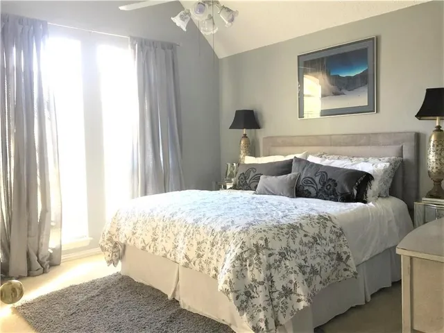 a backyard with table and chairs with wooden fence