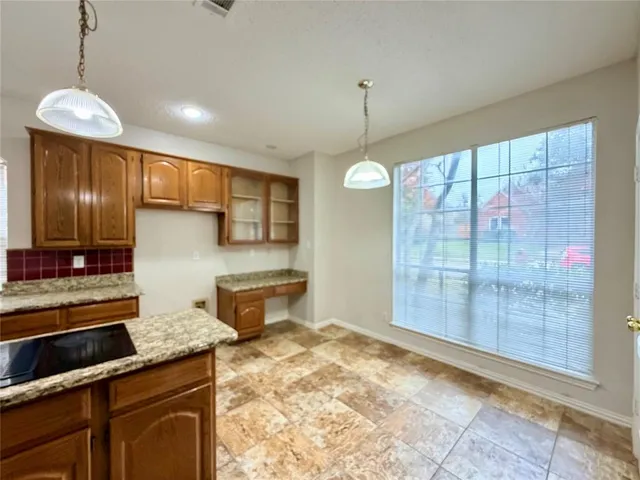 a kitchen with stainless steel appliances granite countertop sink stove and refrigerator