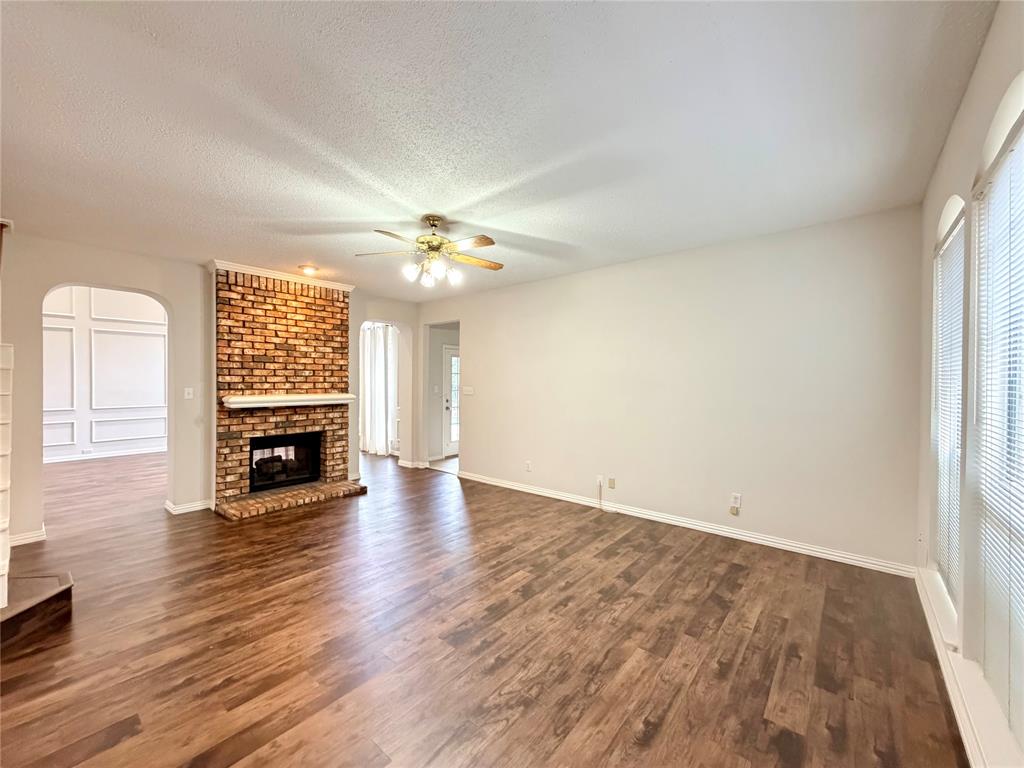 4309 Mead Drive Plano, TX 75024 - Photo 7 of 25 an empty room with wooden floor fireplace and window