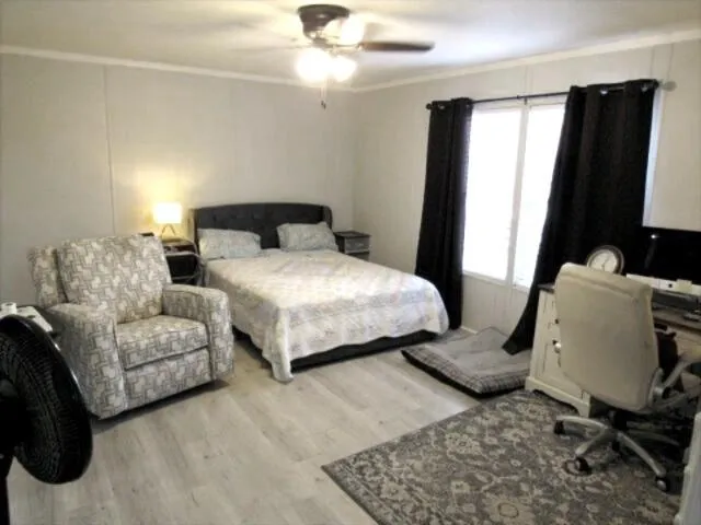 a bedroom with bed chair and window