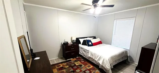 a bedroom with a bed and a mirror