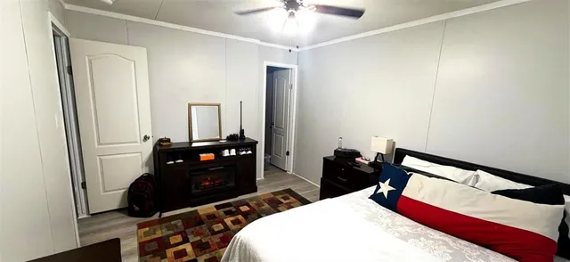 a bedroom with bed and a mirror