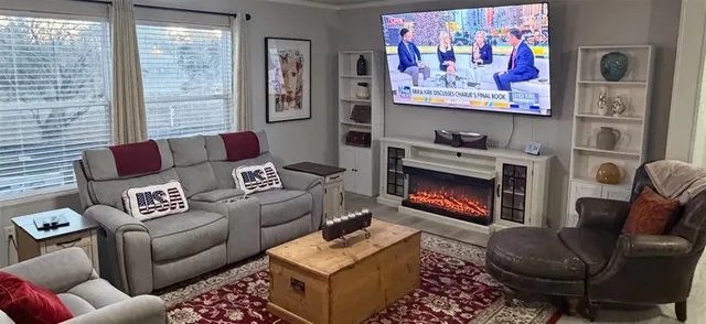 a living room with furniture and a fireplace