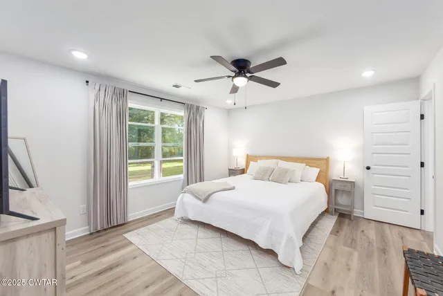 a bedroom with a large bed and a window