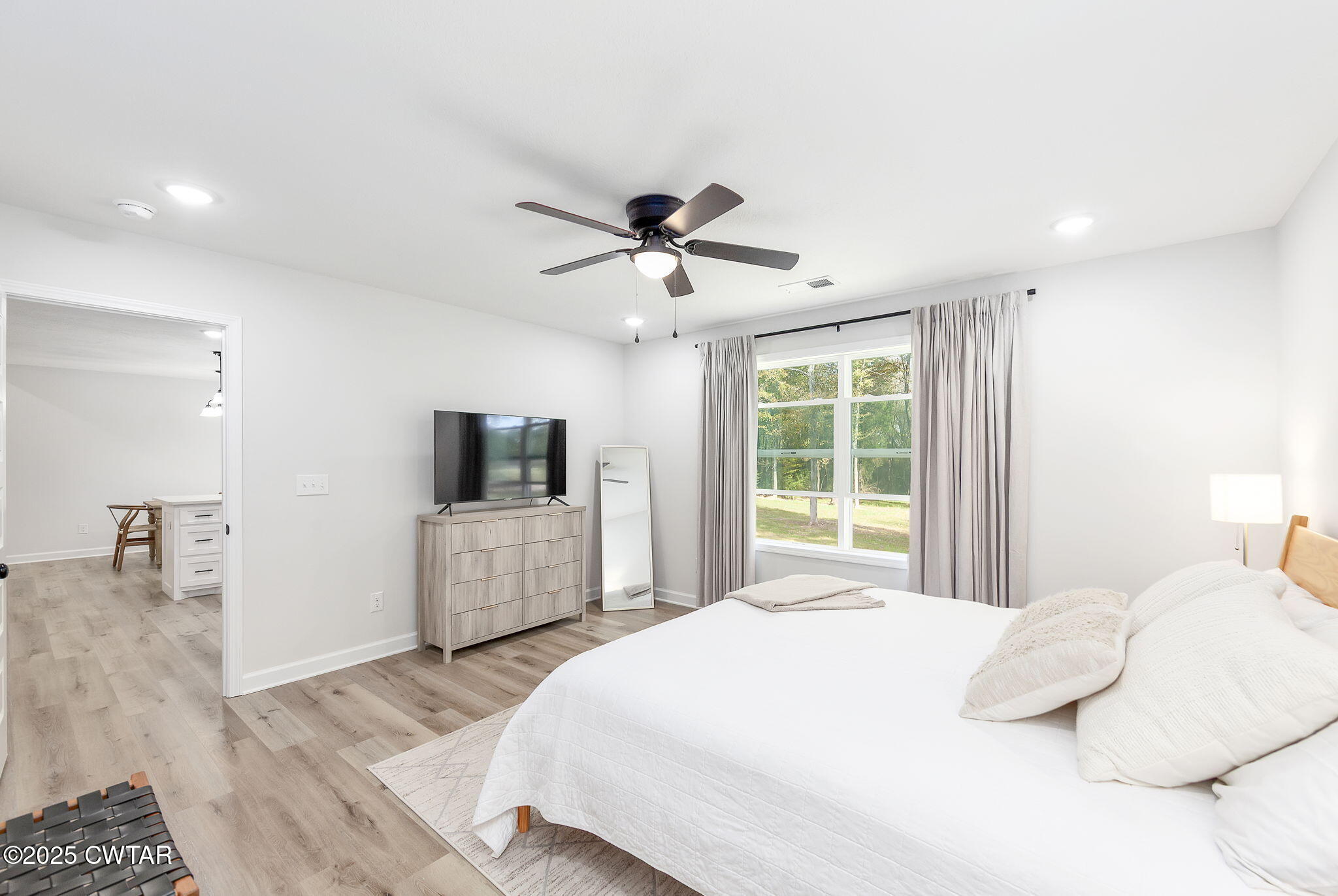 448 Old Jackson Road Henderson, TN 38340 - Photo 13 of 32 a bedroom with a large bed and a flat screen tv