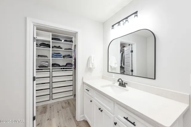 a bathroom with a double vanity sink mirror and