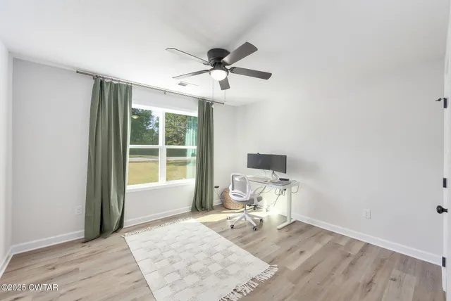 a work room with wooden floor and a window