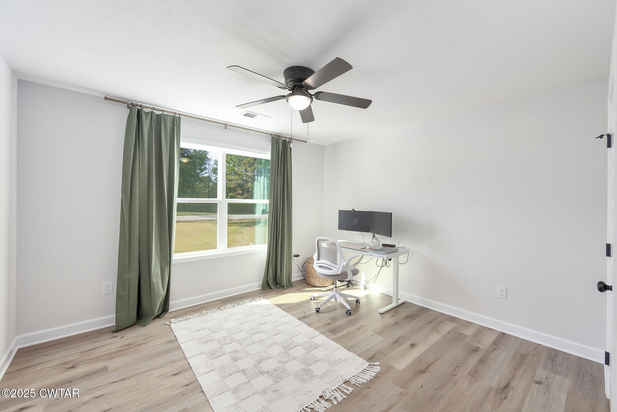 448 Old Jackson Road Henderson, TN 38340 - Photo 16 of 32 a work room with wooden floor and a window
