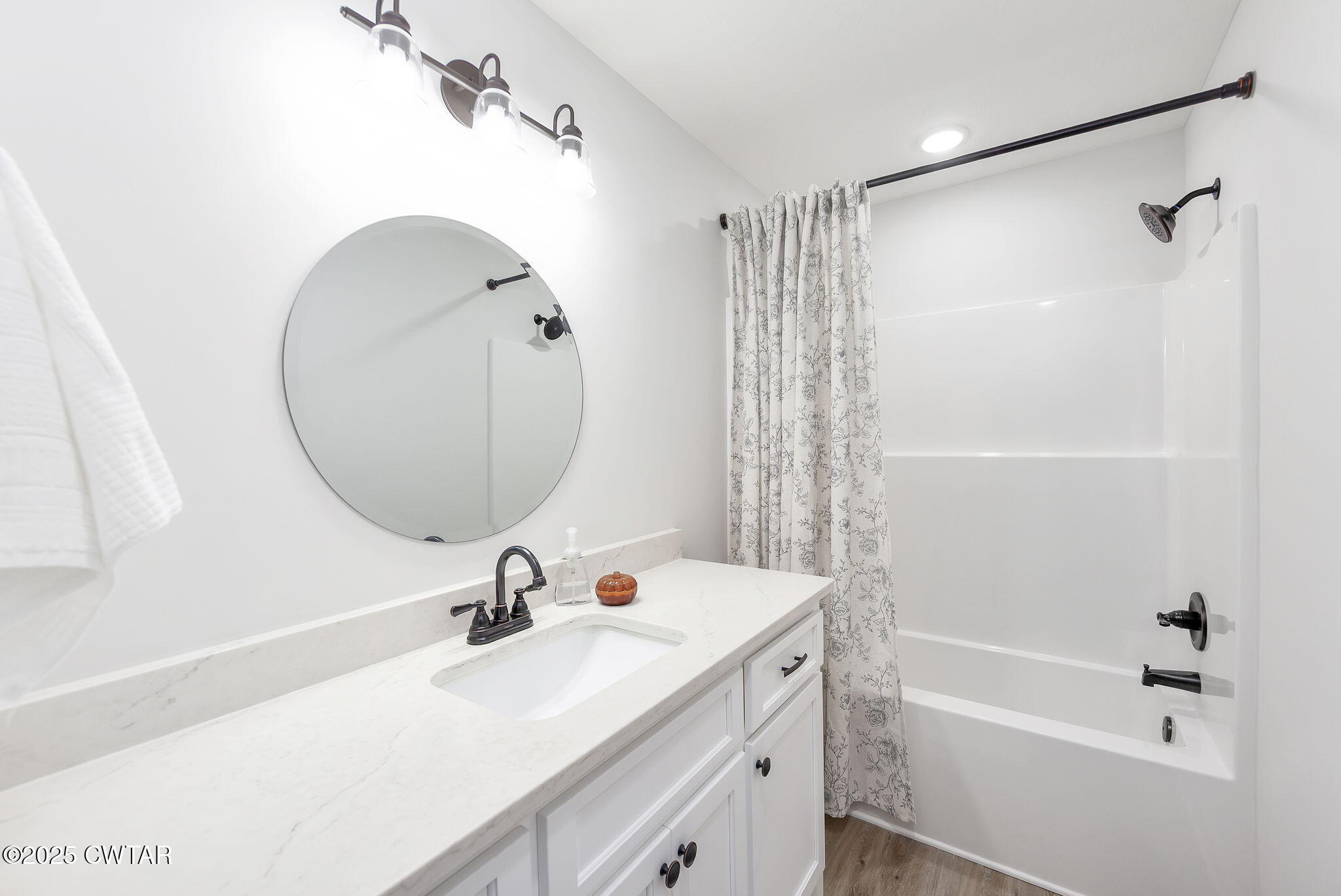 448 Old Jackson Road Henderson, TN 38340 - Photo 18 of 32 a bathroom with a sink a mirror a bathtub and shower