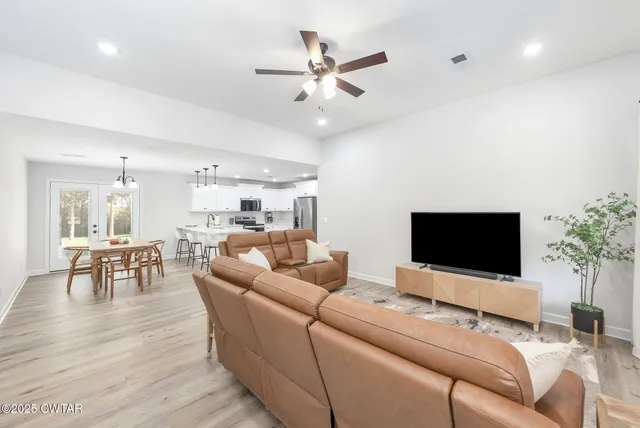 a living room with furniture and a flat screen tv