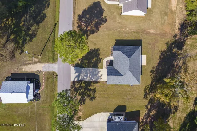 aerial view of a house with a yard