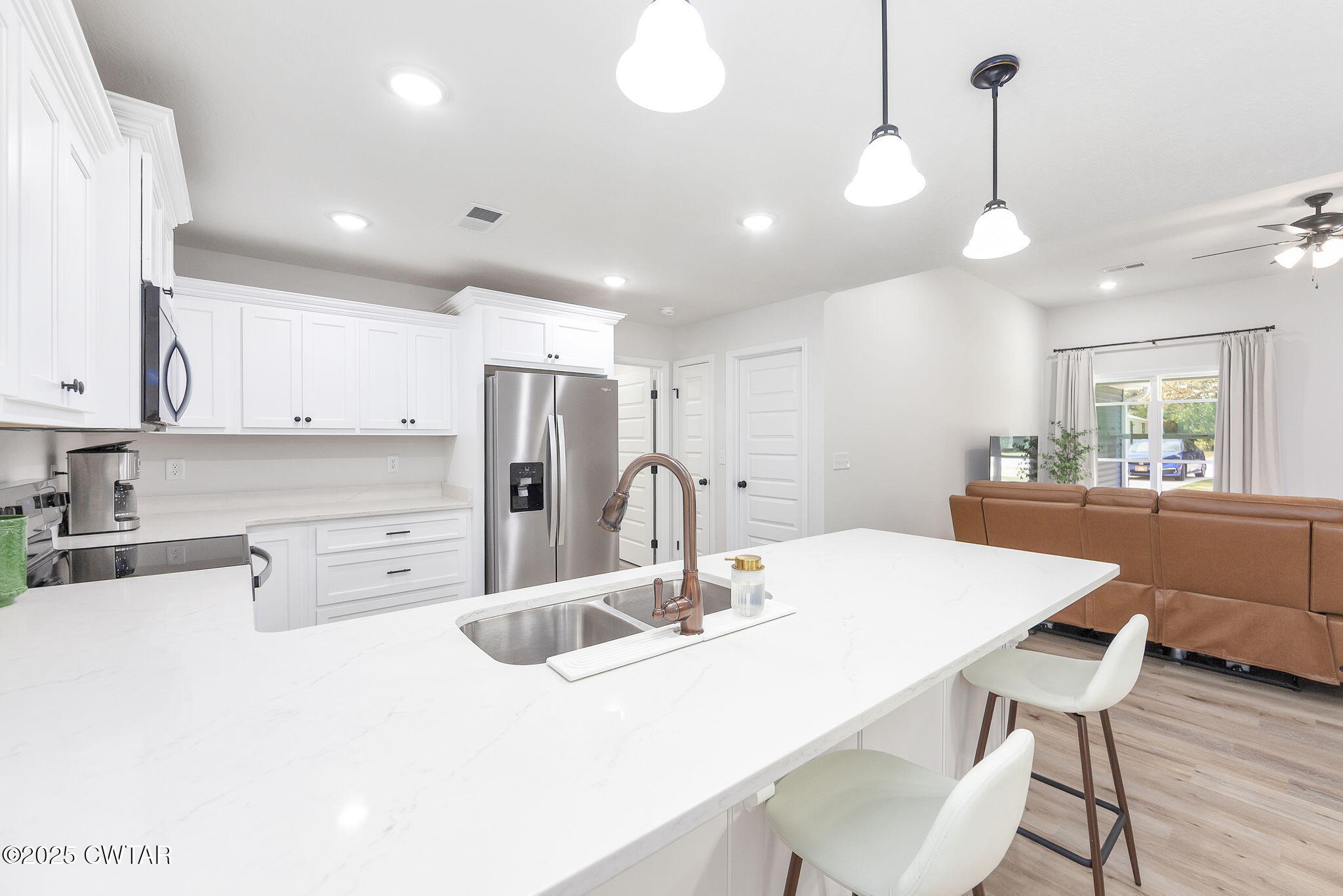 448 Old Jackson Road Henderson, TN 38340 - Photo 8 of 32 a kitchen with stainless steel appliances kitchen island granite countertop a table chairs and a refrigerator