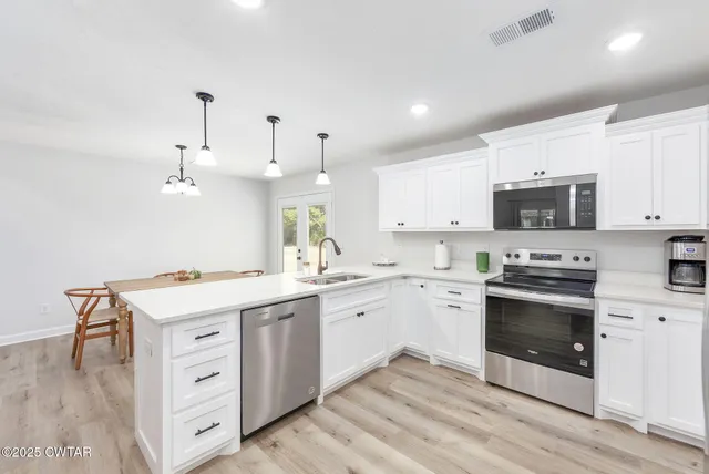 a kitchen with a stove oven and sink
