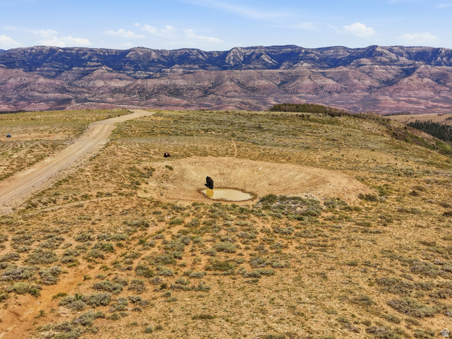 10780 Ford Ridge Road Helper, UT 84526 - Photo 16 of 38 Dirt road, excavated pond, and arid landscape with distant mountains