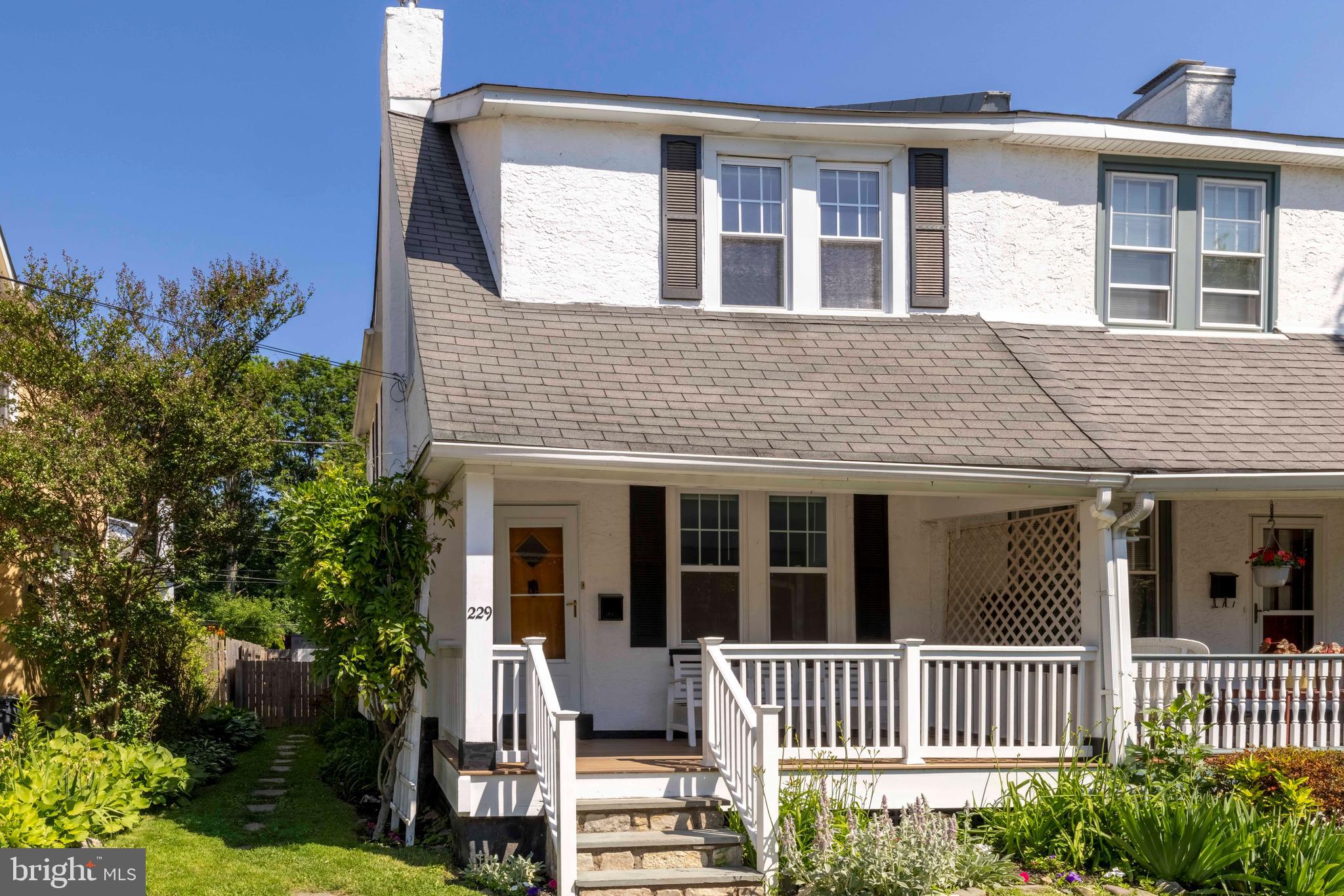 229 Wayne Avenue Narberth, PA 19072 - Photo 3 of 35 a front view of a house with a garden