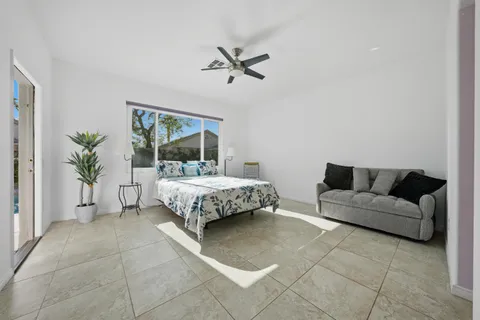 a bedroom with a bed and a couch