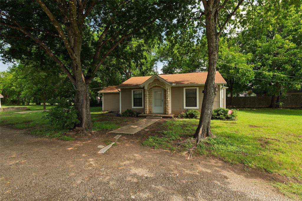 313 North Roe Street White Settlement, TX 76108 - Photo 3 of 33 Single-story residence featuring a neutral-toned exterior and a brown shingle roof