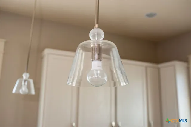 a large white kitchen with a large window