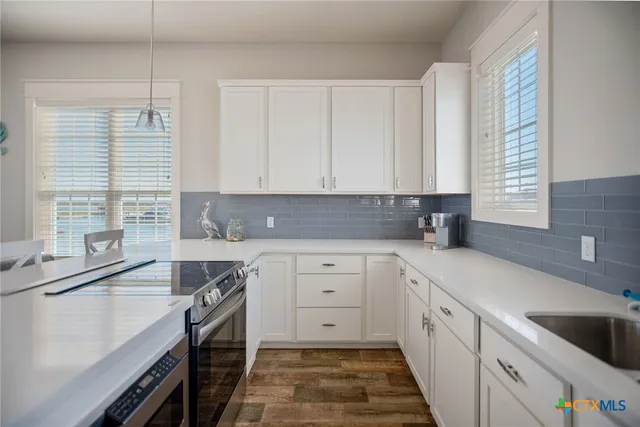 a bathroom with a granite countertop sink a toilet and shower