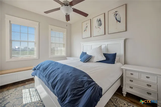 a bathroom with a granite countertop toilet sink and mirror