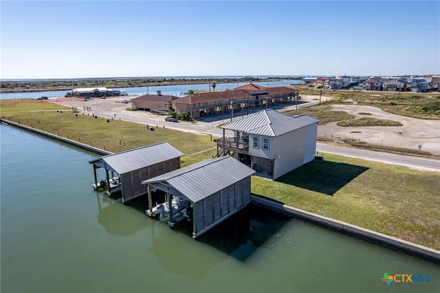 an aerial view of a house with a ocean view