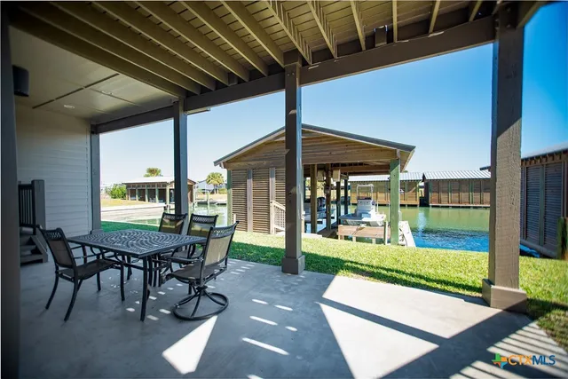 a view of a patio with a table chairs and backyard