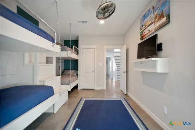 a bathroom with cabinets and mirror