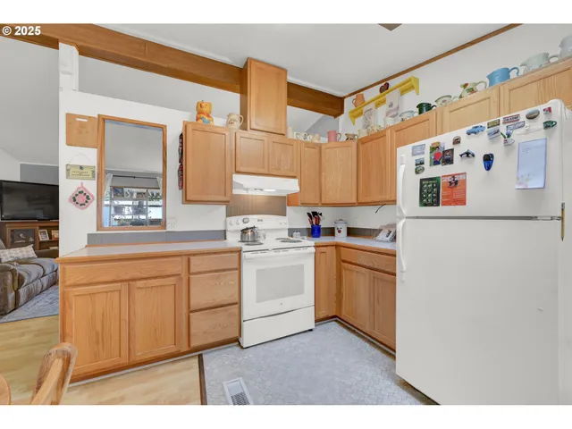 a kitchen with granite countertop cabinets and white appliances
