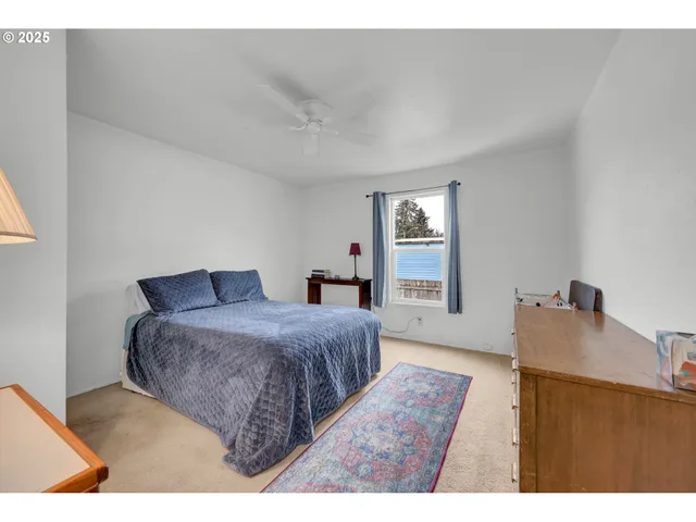 a bedroom with a bed and window