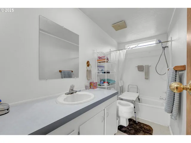 a bathroom with a sink vanity granite and toilet