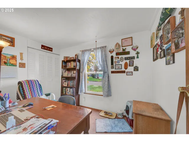 a bedroom with a bed and a bookshelf with wooden floor