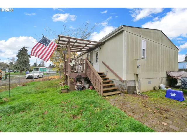 a view of a backyard with a garden and entertaining space