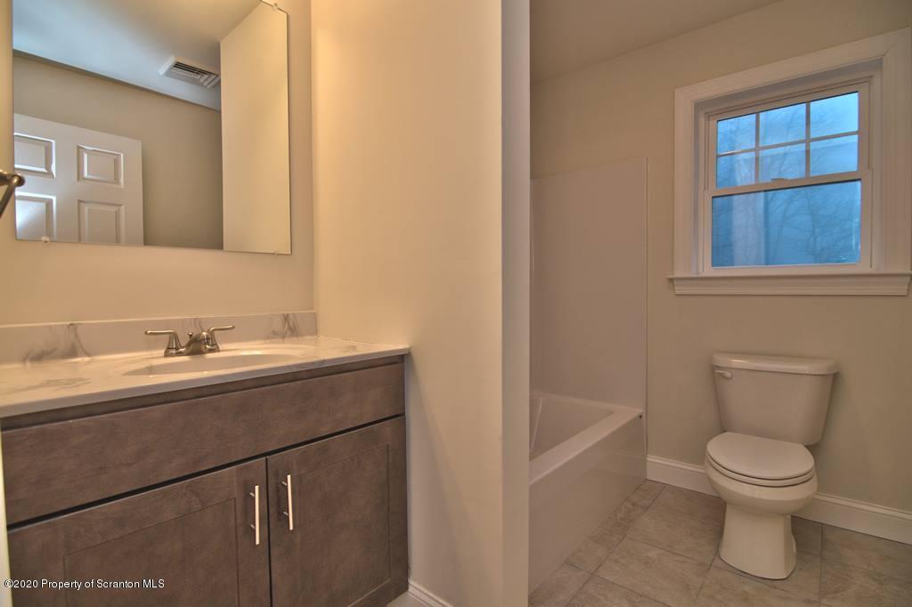 2070 Moosic Lake Road Lake Ariel, PA 18436 - Photo 54 of 59 a bathroom with a sink a toilet and window