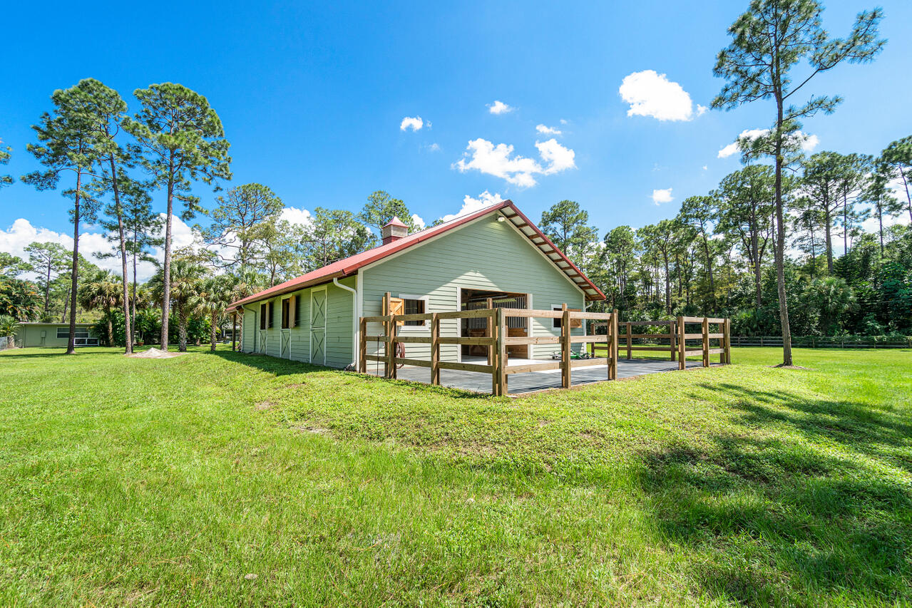 1835 Stallion Drive, Unit STALLS Loxahatchee, FL 33470 - Photo 21 of 35 a view of a house with backyard and sitting area