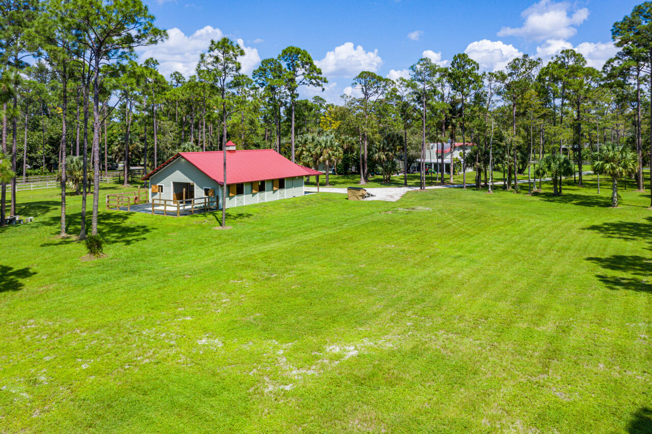 1835 Stallion Drive, Unit STALLS Loxahatchee, FL 33470 - Photo 30 of 35 a view of a house with a yard