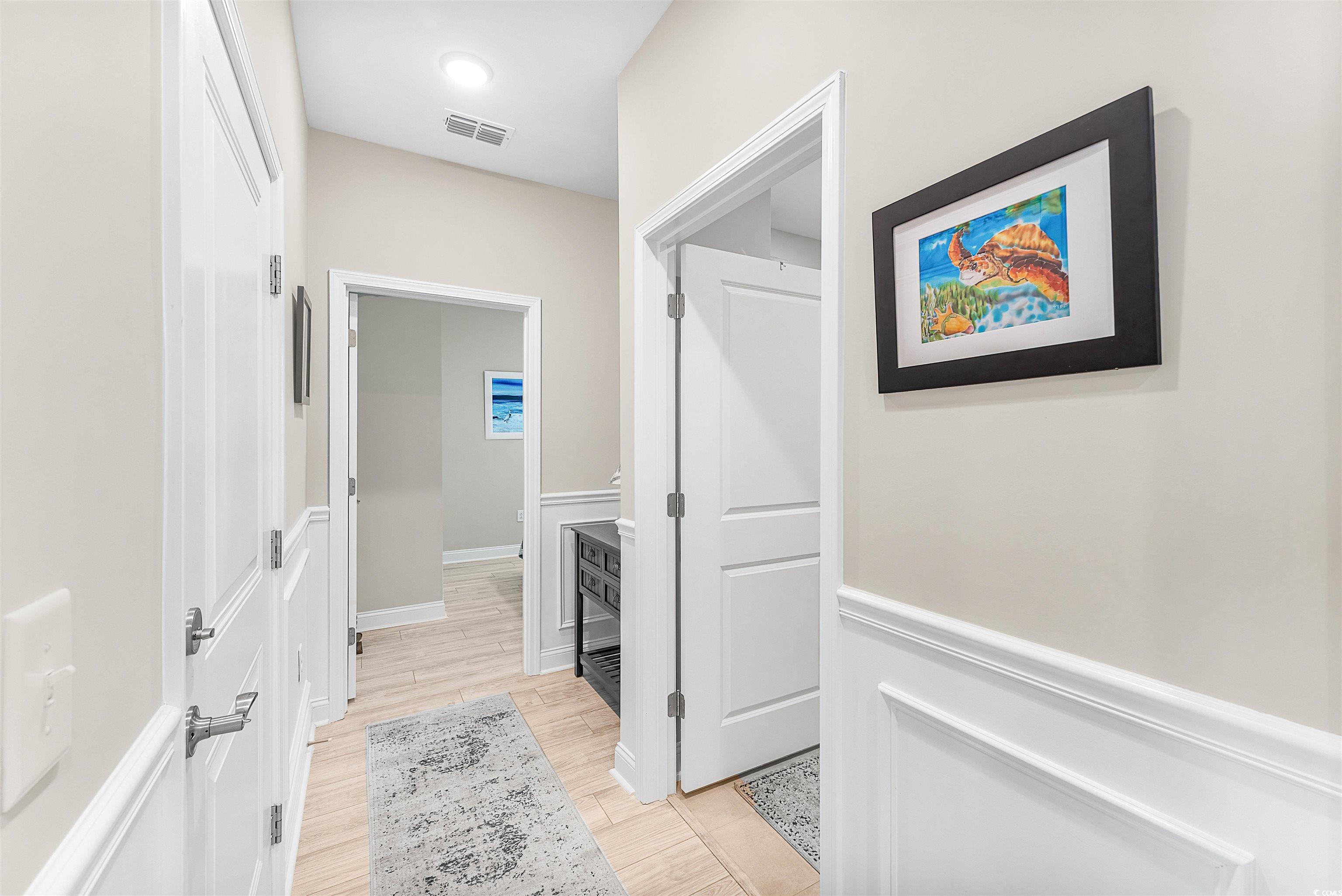 1577 Littleleaf Loop North Myrtle Beach, SC 29582 - Photo 24 of 40 Corridor with visible vents and light wood finishe