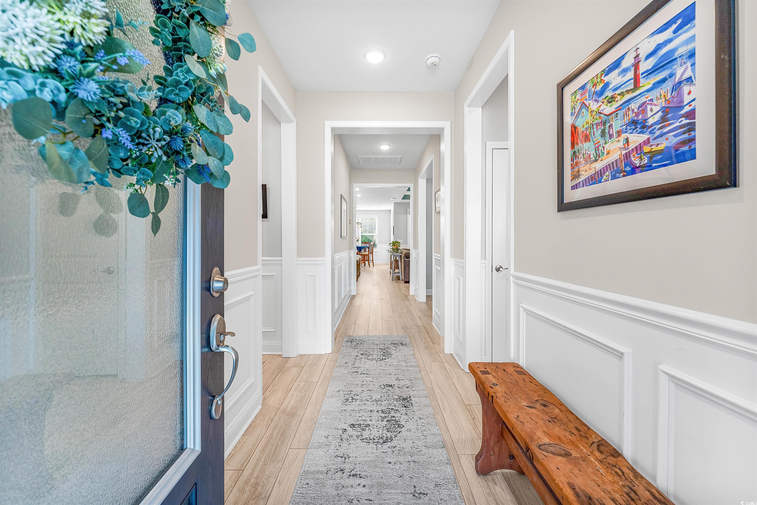 1577 Littleleaf Loop North Myrtle Beach, SC 29582 - Photo 4 of 40 Hallway featuring a wainscoted wall, a decorative