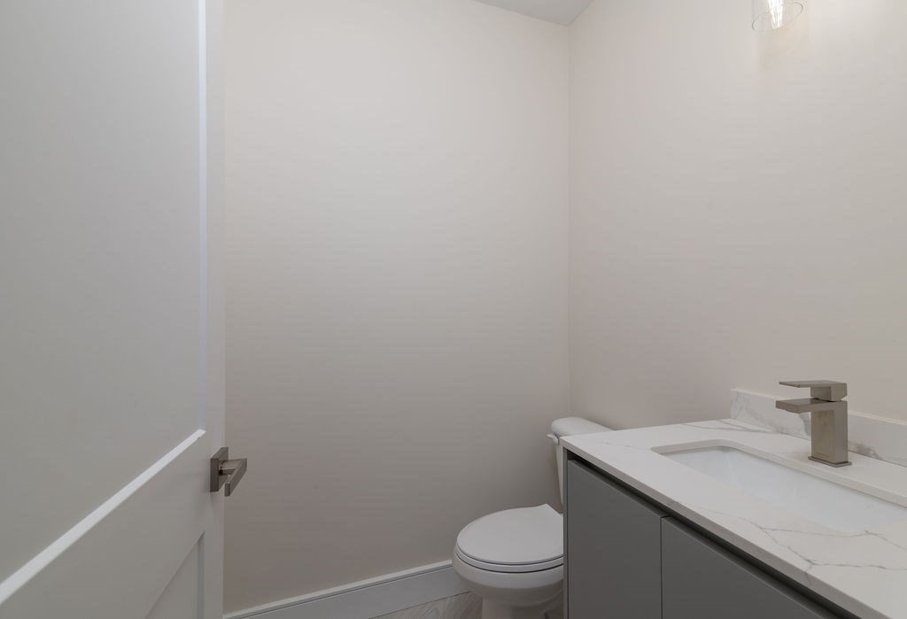 488 Quincy Avenue, Unit 13 Quincy, MA 02169 - Photo 12 of 23 a bathroom with a granite countertop toilet and sink