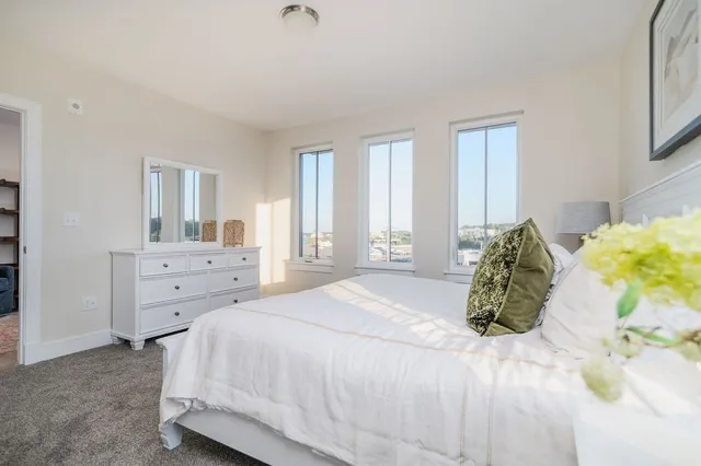 a spacious bedroom with a bed and a couch