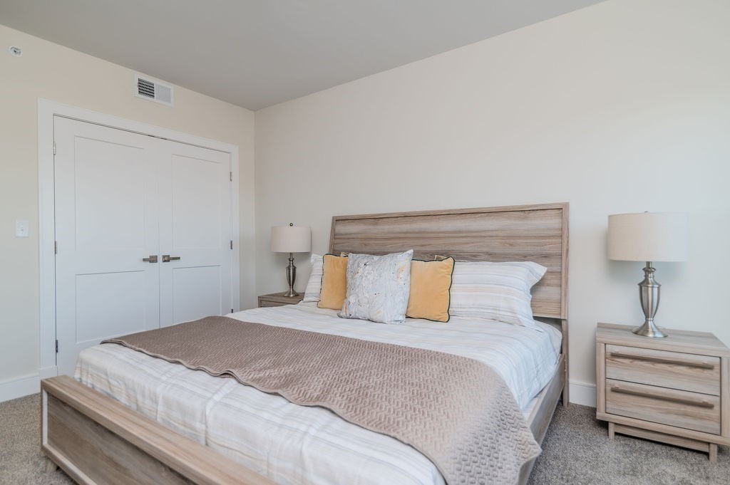 488 Quincy Avenue, Unit 13 Quincy, MA 02169 - Photo 19 of 23 a bedroom with a large bed and lamp