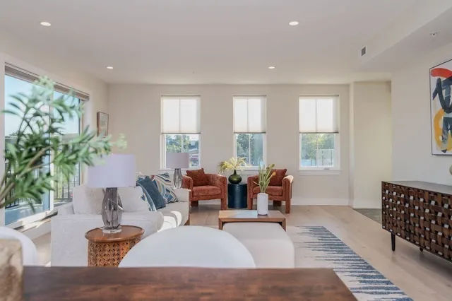 a living room with furniture and a large window