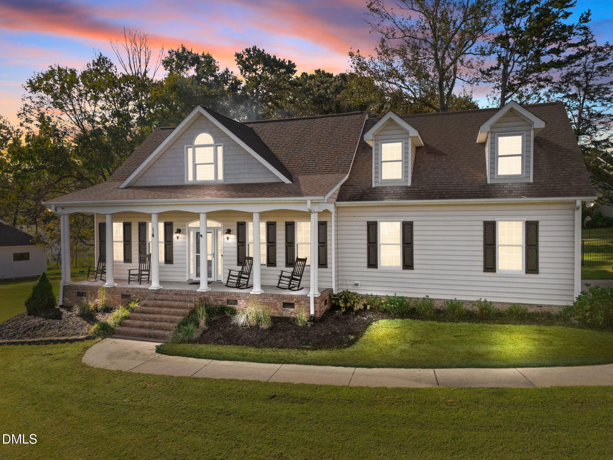 a front view of a house with a yard table and chairs